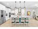 Modern kitchen with island, stainless steel appliances, and white cabinets at 14672 Horse Trot Rd, Lithia, FL 33547