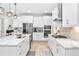 Modern kitchen with white cabinets, stainless steel appliances and quartz countertops at 14672 Horse Trot Rd, Lithia, FL 33547