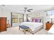 Spacious main bedroom with a king-size bed and a sitting area at 14672 Horse Trot Rd, Lithia, FL 33547