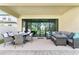 Covered patio with seating area and outdoor dining table at 14672 Horse Trot Rd, Lithia, FL 33547