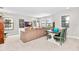 Bright playroom with a sectional sofa and a wooden table at 14672 Horse Trot Rd, Lithia, FL 33547