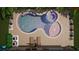 Unique freeform pool design with a waterfall feature and tanning ledge at 14672 Horse Trot Rd, Lithia, FL 33547