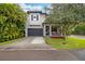 Two-story home with gray siding, a dark gray garage door, and a landscaped front yard at 1839 46Th N Ave, St Petersburg, FL 33714