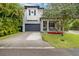 Two-story home with gray siding, a dark gray garage door, and a landscaped front yard at 1839 46Th N Ave, St Petersburg, FL 33714