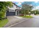 Two-story home with gray siding, a dark gray garage door, and a basketball hoop at 1839 46Th N Ave, St Petersburg, FL 33714
