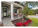 Cozy front porch with white railings, red poinsettias, and holiday garland at 1839 46Th N Ave, St Petersburg, FL 33714