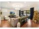 Spacious living room featuring hardwood floors, comfortable seating, and a large TV at 1839 46Th N Ave, St Petersburg, FL 33714