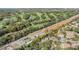 Aerial view of community near golf course and body of water at 2122 Oak Forest Ln, Palm Harbor, FL 34683