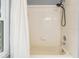 Simple bathroom with shower/tub combo and a window at 2122 Oak Forest Ln, Palm Harbor, FL 34683