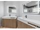 Double vanity bathroom with modern light fixtures and wood accents at 2122 Oak Forest Ln, Palm Harbor, FL 34683