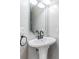 Elegant pedestal sink with modern fixtures in a half bathroom at 2122 Oak Forest Ln, Palm Harbor, FL 34683