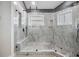 Large walk-in shower with marble tile and glass enclosure at 2122 Oak Forest Ln, Palm Harbor, FL 34683