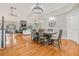 Bright dining room with hardwood floors, chandelier and views to living room and kitchen at 2122 Oak Forest Ln, Palm Harbor, FL 34683