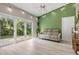 Bright Gathering room features sliding doors to backyard, comfy couch, and accent wall at 2122 Oak Forest Ln, Palm Harbor, FL 34683