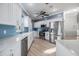 Modern kitchen with white cabinets, stainless steel appliances, and blue tile backsplash at 2122 Oak Forest Ln, Palm Harbor, FL 34683
