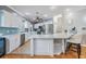 Modern kitchen with white cabinets, quartz countertops and stainless steel appliances at 2122 Oak Forest Ln, Palm Harbor, FL 34683