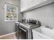 Laundry room with washer, dryer, utility sink, and cabinet storage at 2122 Oak Forest Ln, Palm Harbor, FL 34683