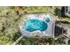 Community pool and spa with surrounding patio and lounge chairs at 2122 Oak Forest Ln, Palm Harbor, FL 34683