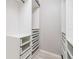 Large walk-in closet with ample shelving and drawers at 2122 Oak Forest Ln, Palm Harbor, FL 34683