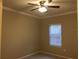 Simple bedroom with tile floor, window, and ceiling fan at 2171 Portofino Pl # 27-2717, Palm Harbor, FL 34683