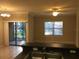 Bright dining area with tile floor and sliding glass door at 2171 Portofino Pl # 27-2717, Palm Harbor, FL 34683