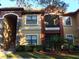 Two-story condo building with stone accents and balconies at 2171 Portofino Pl # 27-2717, Palm Harbor, FL 34683