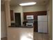 Kitchen with dark wood cabinets and white appliances at 2171 Portofino Pl # 27-2717, Palm Harbor, FL 34683