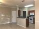 Kitchen with dark wood cabinets and white appliances at 2171 Portofino Pl # 27-2717, Palm Harbor, FL 34683