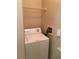 Laundry room with washer, shelving and electrical panel at 2171 Portofino Pl # 27-2717, Palm Harbor, FL 34683