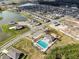 Aerial view of community with homes, pool, and lake at 2941 Adams Cross Dr, Zephyrhills, FL 33540