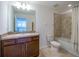 Clean bathroom with tub/shower combo and wood vanity at 2941 Adams Cross Dr, Zephyrhills, FL 33540