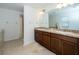 Double vanity bathroom with a walk-in shower and tile flooring at 2941 Adams Cross Dr, Zephyrhills, FL 33540