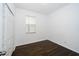 Simple bedroom with dark hardwood floors and a double door closet at 2941 Adams Cross Dr, Zephyrhills, FL 33540