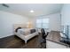 Bright bedroom featuring a built-in desk and hardwood floors at 2941 Adams Cross Dr, Zephyrhills, FL 33540