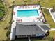 Community pool and clubhouse with lounge chairs at 2941 Adams Cross Dr, Zephyrhills, FL 33540