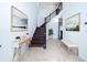 Bright and spacious entryway with a wooden staircase and decorative artwork at 2941 Adams Cross Dr, Zephyrhills, FL 33540