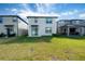 Two-story home with sliding glass doors and backyard at 2941 Adams Cross Dr, Zephyrhills, FL 33540