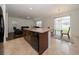 Open concept kitchen with island, stainless steel appliances, and breakfast bar at 2941 Adams Cross Dr, Zephyrhills, FL 33540