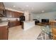 Open concept kitchen with island and views into living and dining areas at 2941 Adams Cross Dr, Zephyrhills, FL 33540