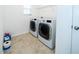 Bright laundry room with washer, dryer, and shelving at 2941 Adams Cross Dr, Zephyrhills, FL 33540