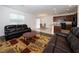 Relaxing living room with dark brown leather couches and a wood coffee table at 2941 Adams Cross Dr, Zephyrhills, FL 33540