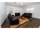 Spacious living room with two leather sofas and a flat-screen TV at 2941 Adams Cross Dr, Zephyrhills, FL 33540