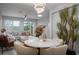 Elegant dining area with a round marble table and modern chandelier at 29955 Southwell Ln, Wesley Chapel, FL 33543