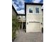 Two-story townhome with a two-car garage and a well-manicured front yard at 29955 Southwell Ln, Wesley Chapel, FL 33543