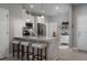 Modern kitchen with a breakfast bar, white cabinets, and stainless steel appliances at 29955 Southwell Ln, Wesley Chapel, FL 33543