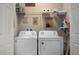 Convenient laundry room with washer, dryer, and storage shelves at 29955 Southwell Ln, Wesley Chapel, FL 33543