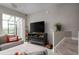 Cozy living room featuring a fireplace and a view into a screened-in patio at 29955 Southwell Ln, Wesley Chapel, FL 33543