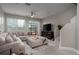 Spacious living room featuring a sectional sofa and a large TV at 29955 Southwell Ln, Wesley Chapel, FL 33543