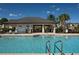 Community pool with a covered patio and lounge chairs at 29955 Southwell Ln, Wesley Chapel, FL 33543