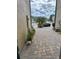 Neatly paved side yard with plants and access to the street at 29955 Southwell Ln, Wesley Chapel, FL 33543